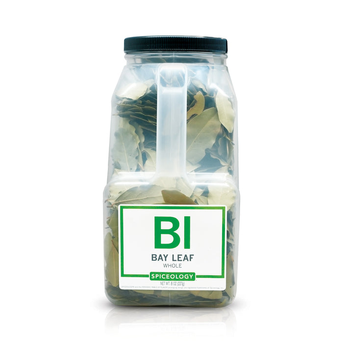 A bottle of Spiceology bay leaves on a white background