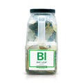 A bottle of Spiceology bay leaves on a white background