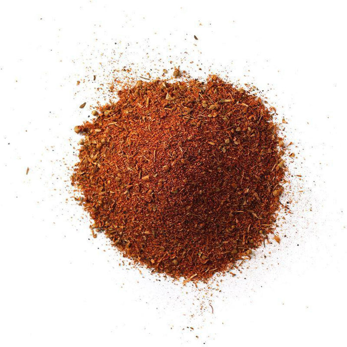 Closeup of a rusty red powder with light tan flakes mixed in