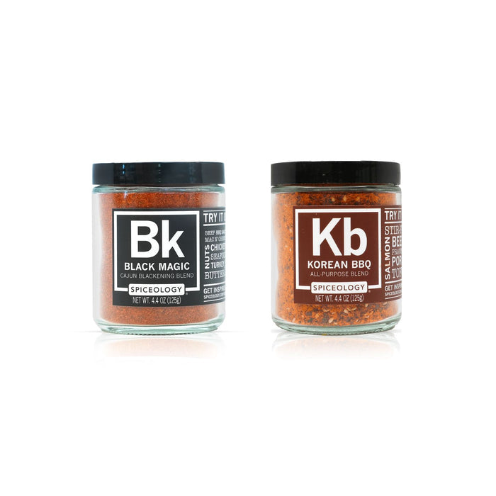 Two jars of spice mix labeled 'Black Magic' and 'Korean BBQ' on a white background
