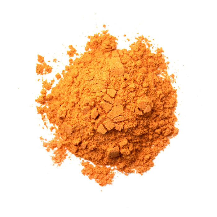 Closeup of a bright, light orange chunky powder
