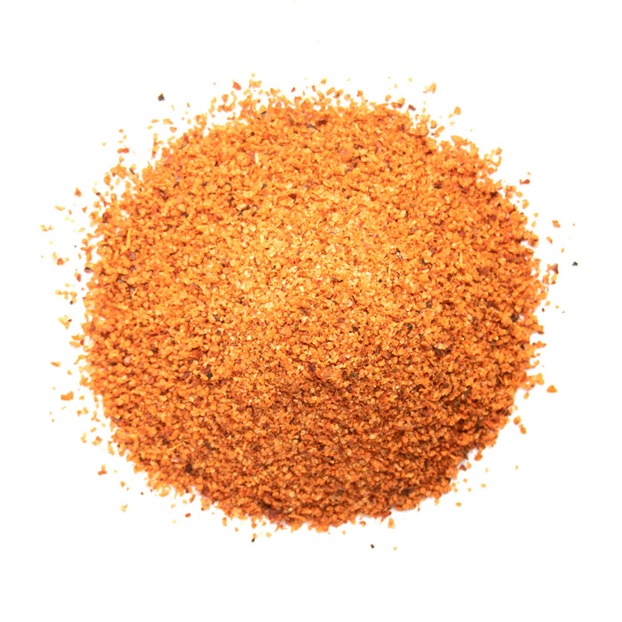 Closeup of orange granules with small red flecks mixed in