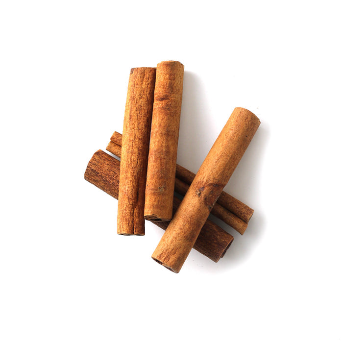 Closeup of dried, reddish-brown, rolled strips of Cinnamon bark