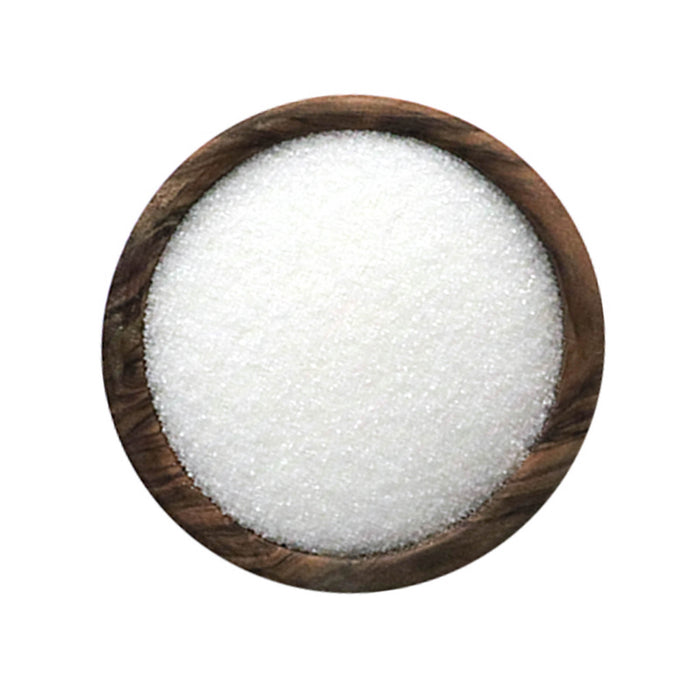 Closeup of white granules in a wooden bowl