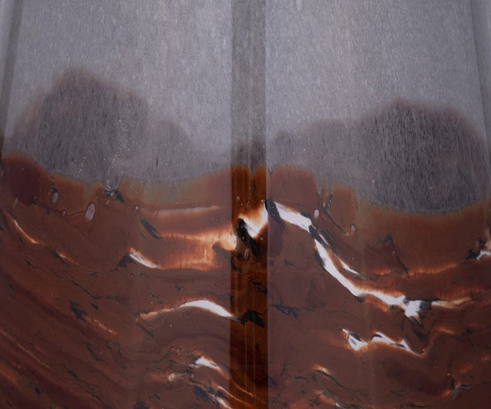 Close-up of the Copper Core Vase’s brown and gray marbled surface, featuring swirling streaks and glossy reflections that evoke abstract patterns—showcasing the elegant artistry reminiscent of hand-finished glasswork.