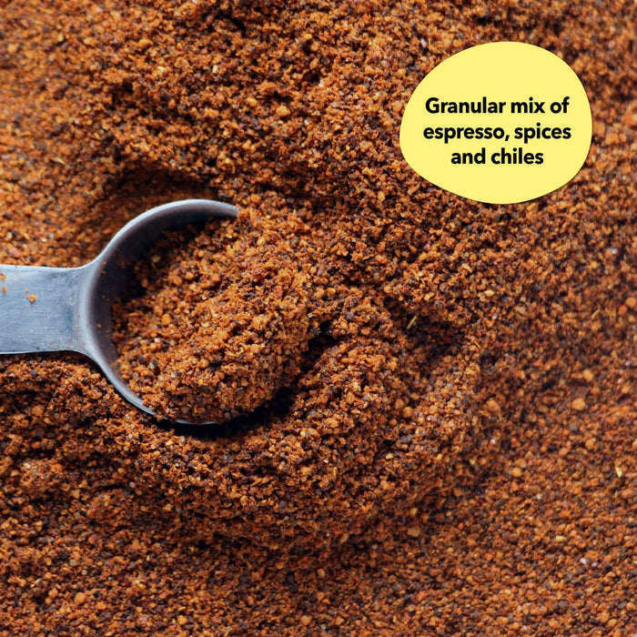 Overhead close-up of a dark reddish-brown spice blend with a silver measuring spoon; a callout reads Granular mix of espresso, spices and chiles