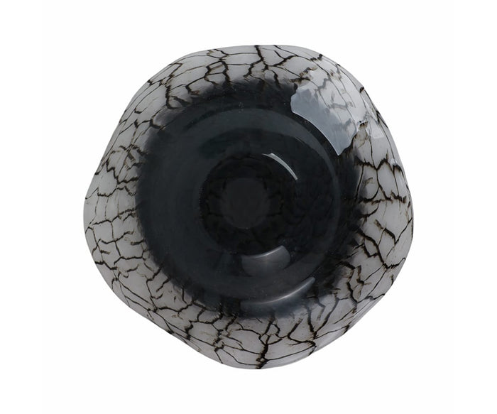 Top view of the Crackle Abstract Bowl, a hand-finished glass piece featuring a black center and white rim enhanced by dark, crackled lines reminiscent of marble or cracked ice. The modern matte finish contrasts elegantly with glossy details for a striking effect.