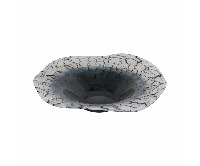 The Crackle Abstract Bowl is a decorative piece featuring a wide, ruffled edge and a cracked black-and-white pattern that darkens toward the center. Its glossy interior and abstract, organic design showcase seamless hand-finished glass artistry, making it a striking display item.