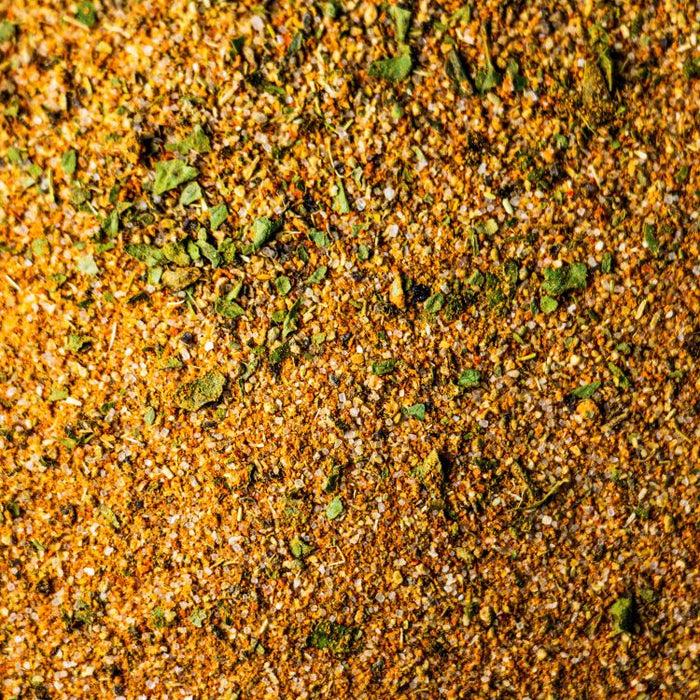 Close-up of orange granular and green flake spice