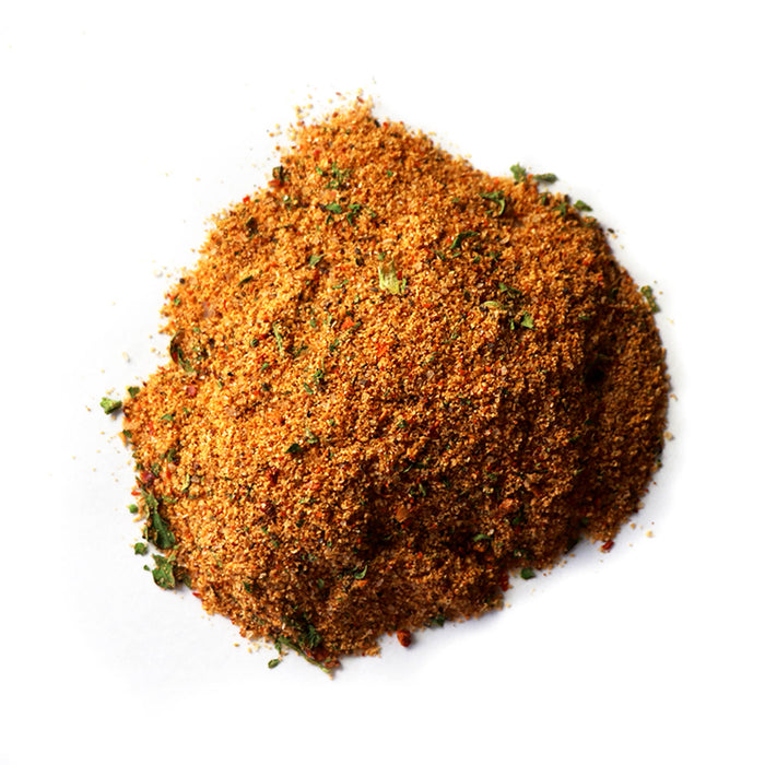 Closeup of red-orange granules with large green flakes mixed in