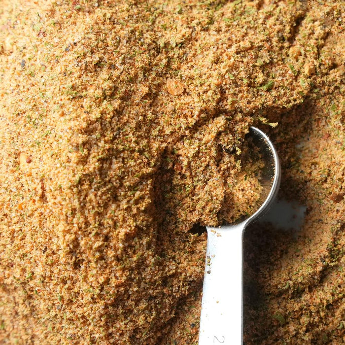 Metal measuring spoon in a pile of Cowboy Butter