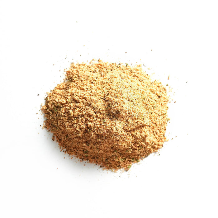 Closeup of off-white powder with small green flakes