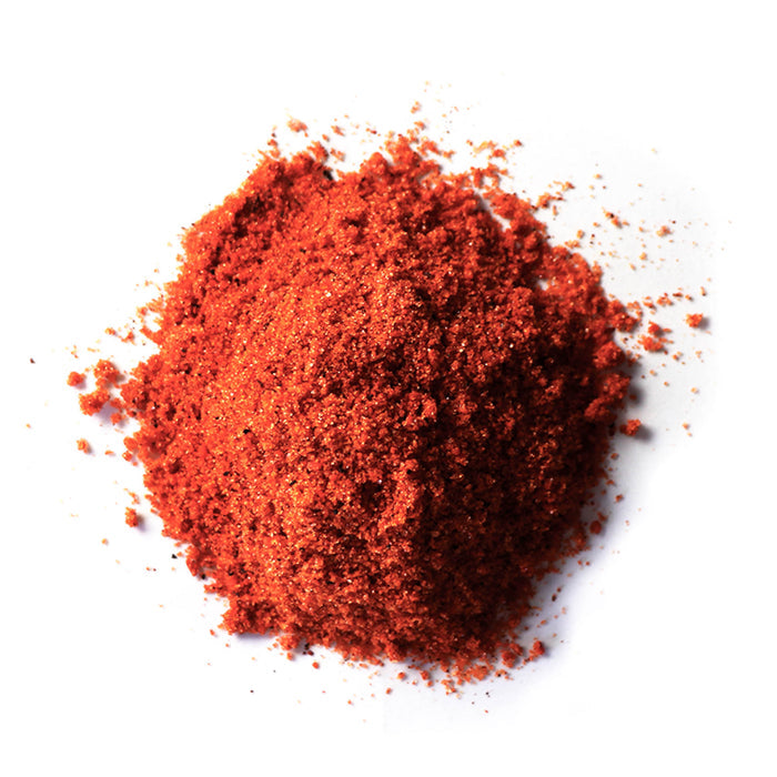 Closeup of dark red granules with orange granules mixed in
