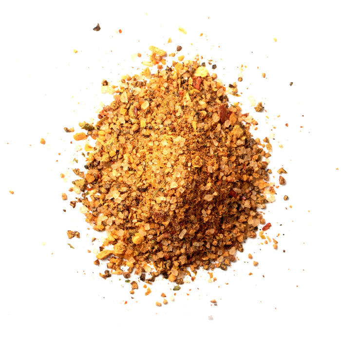 Closeup of golden tan granules with yellow, orange and light brown flakes mixed in