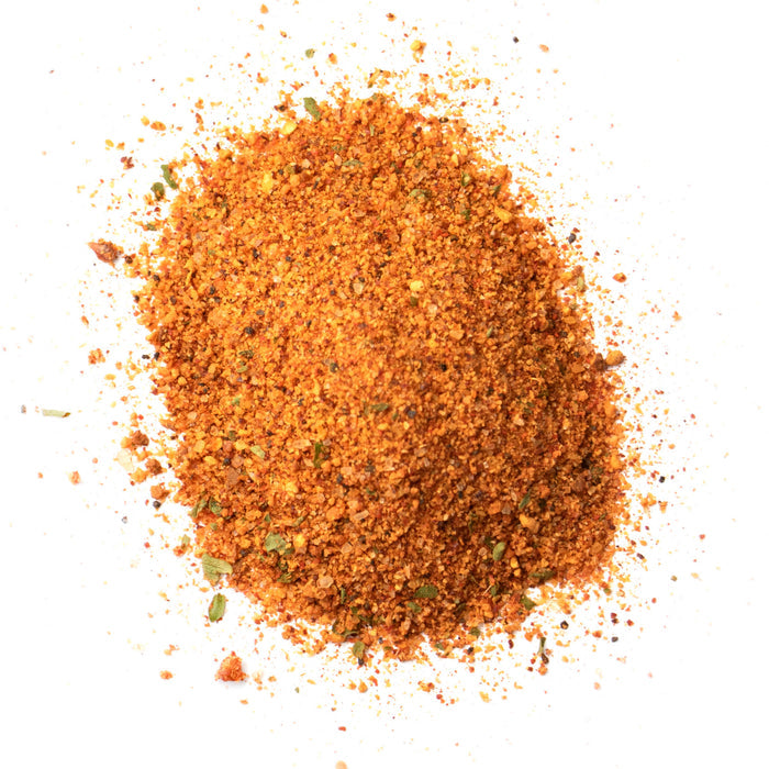 Closeup of orange granules with light green flakes mixed in