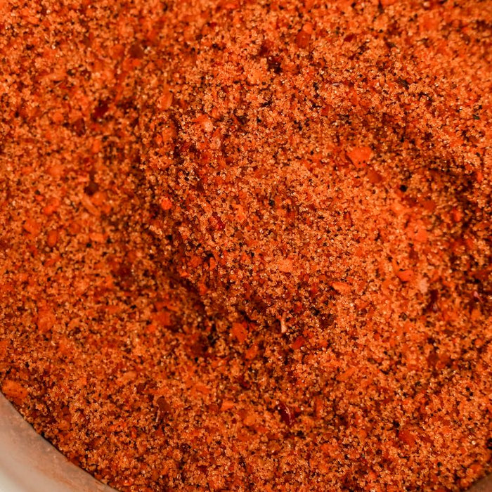 Close-up of a red spice blend in a container
