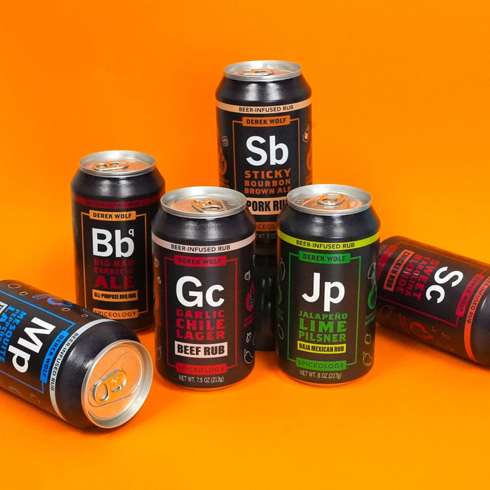 Collection of Spiceology Derek Wolf beer cans with various labels on an orange background