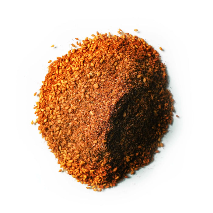 Closeup of red powder with orange seeds