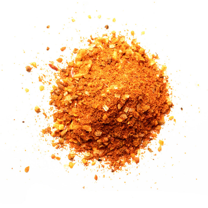 Closeup of light orange powder with yellow flakes mixed in