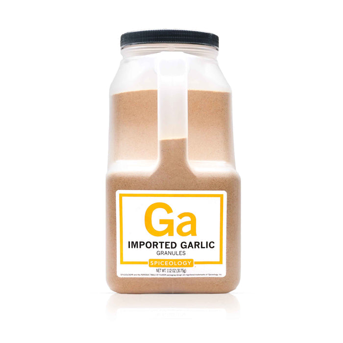 Bottle of Spiceology garlic granules imported on a white background