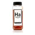 Bottle of Spiceology Harissa blend with a black lid on a white background