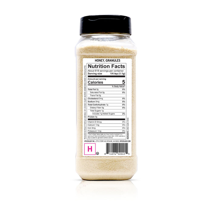 Bottle of honey granules with nutrition facts label on a white background