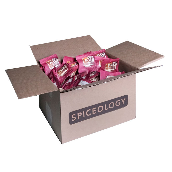 Cardboard box labeled 'Spiceology' filled with Korean BBQ packets on a white background