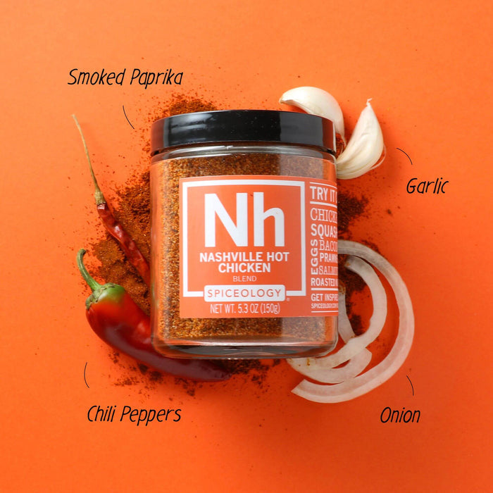 Spiceology Nashville Hot Chicken 9oz jar on an orange background with labeled ingredient callouts for Smoked Paprika, Garlic, Chile Peppers, and Onion surrounding the jar