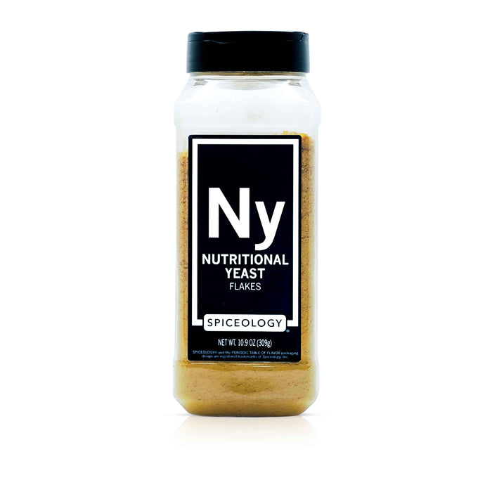 A bottle of Spiceology nutritional yeast flakes on a white background