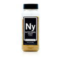 A bottle of Spiceology nutritional yeast flakes on a white background