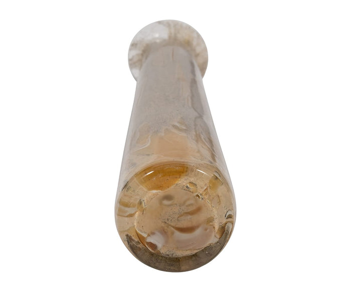 A close-up view of the Ochre Wash Bottle, featuring a clear, cylindrical, hand-finished rod with subtle cloudy or bubbly textures inside, photographed from the bottom end against a white background.
