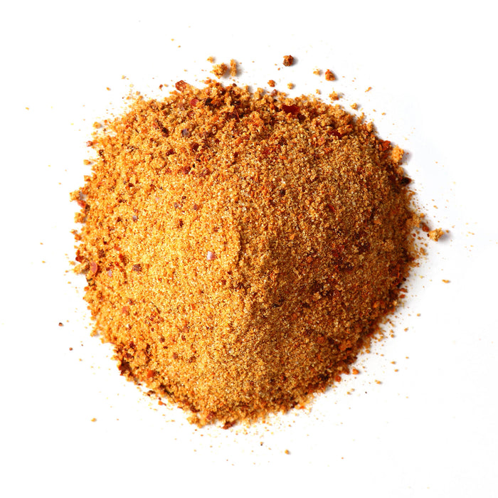 Closeup of orange granules with red flakes mixed in