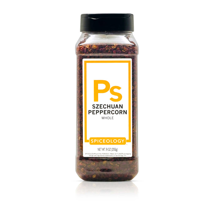 A clear spice jar labeled Blackberry Balsamic Tangy Blend by Spiceology, featuring a purple label with white text and a black lid. The spice inside appears as a fine pinkish powder.