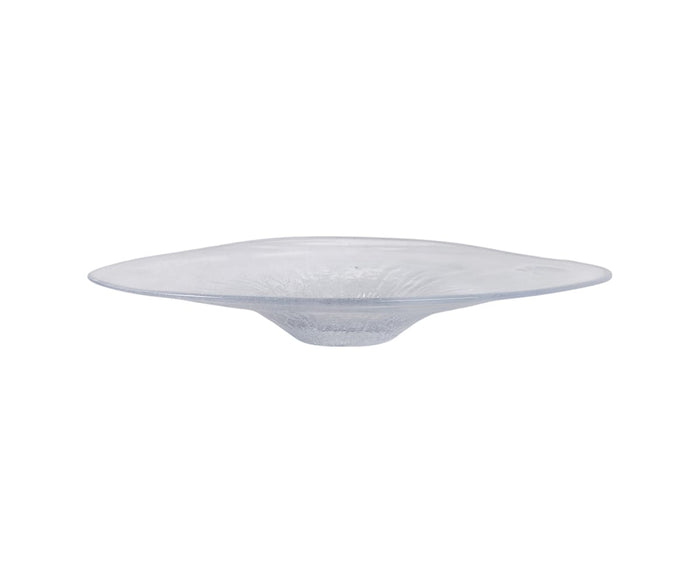 The Petal Frost Bowl is a transparent, flat glass plate with a wide rim and a shallow, indented center, viewed from the side against a white background. Expertly hand-finished, this decorative bowl highlights the artistry and craftsmanship of the Petal Frost Bowl collection.