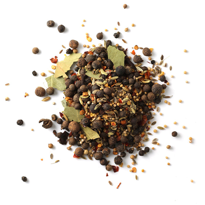 Closeup of bay leaves, whole peppercorns, mustard seeds, fennel, allspice berries and whole cloves