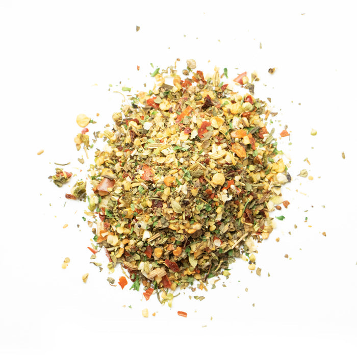 Closeup of green flakes with light yellow and red flakes mixes in