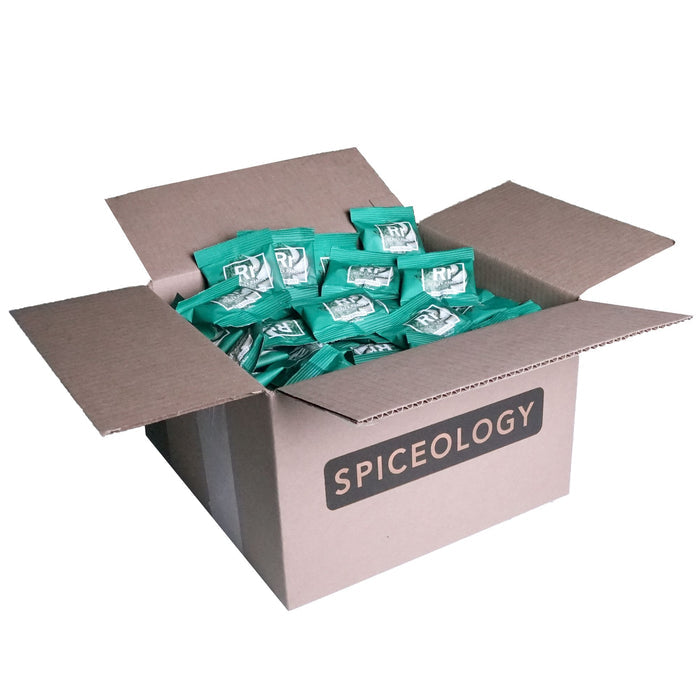 Cardboard box labeled 'Spiceology' filled with Really Ranch packets on a white background