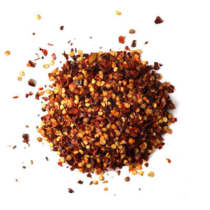 Closeup of red chili flakes and red chili seeds