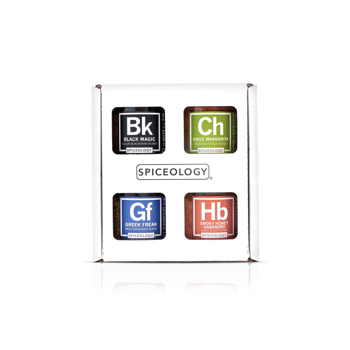 Box of Spiceology rub set 4 pack spice with Black Magic, Chile Margarita, Greek Freak and Smokey Honey Habanero on a white background