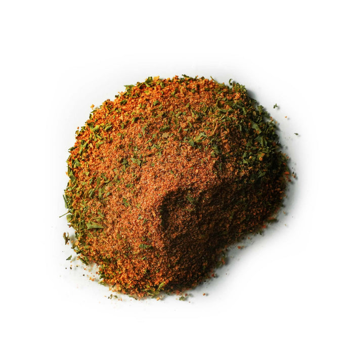 Closeup of light brown granules with green leafy flecks mixed in