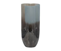 Tall, cylindrical metallic Twilight Vase with a glossy, reflective surface. The color transitions from deep blue at the base to a lighter blue and multi-tonal hues at the top, adding to its refined contemporary vase aesthetic. The rim of this Twilight Vase features a subtle, rounded wave pattern that enhances its modern appeal.