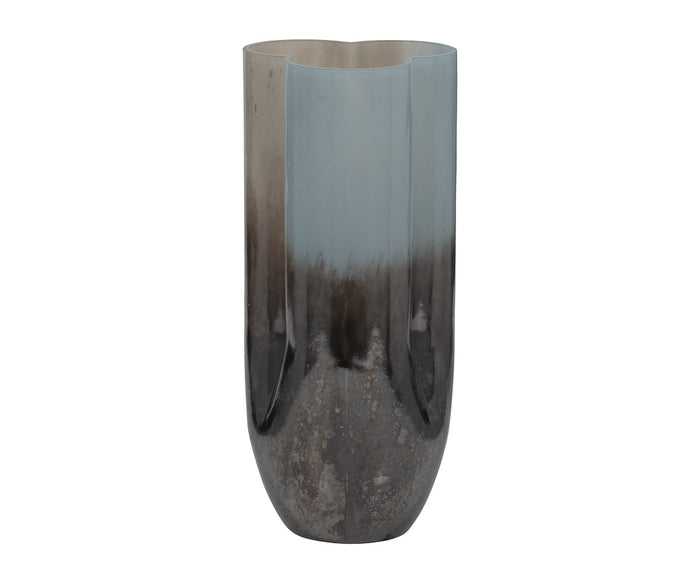 Tall, cylindrical metallic Twilight Vase with a glossy, reflective surface. The color transitions from deep blue at the base to a lighter blue and multi-tonal hues at the top, adding to its refined contemporary vase aesthetic. The rim of this Twilight Vase features a subtle, rounded wave pattern that enhances its modern appeal.