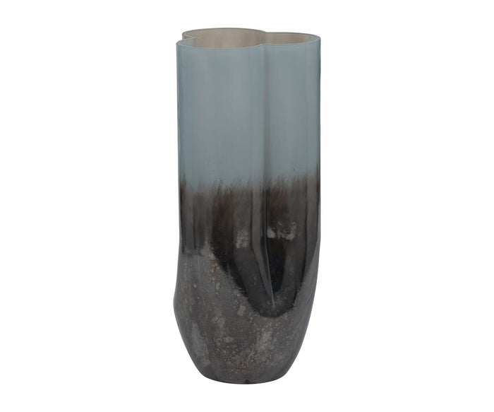 The Twilight Vase is a tall, modern piece with a glossy finish. Its contemporary design features an uneven, organic shape and a surface that transitions from light gray at the top to rich, dark earthy tones at the base.