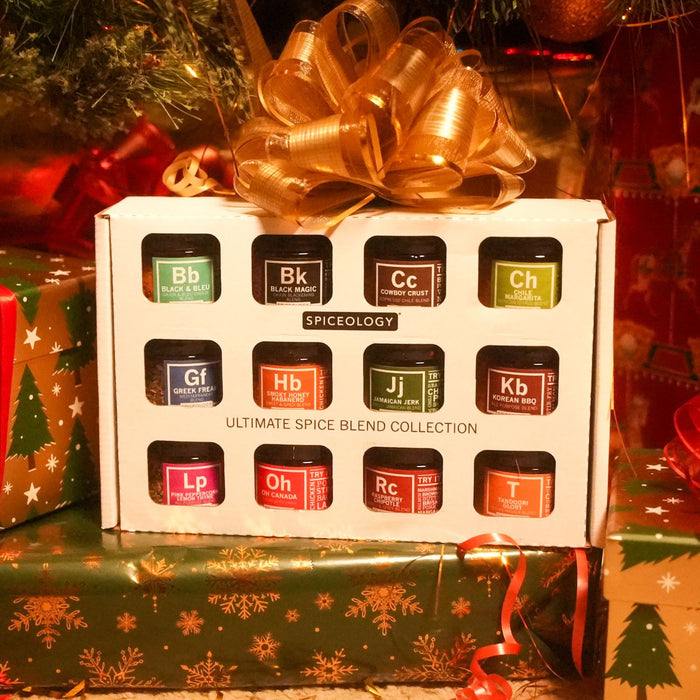Box of Spiceology Ultimate Spice Blend Collection with a gold bow on a festive background