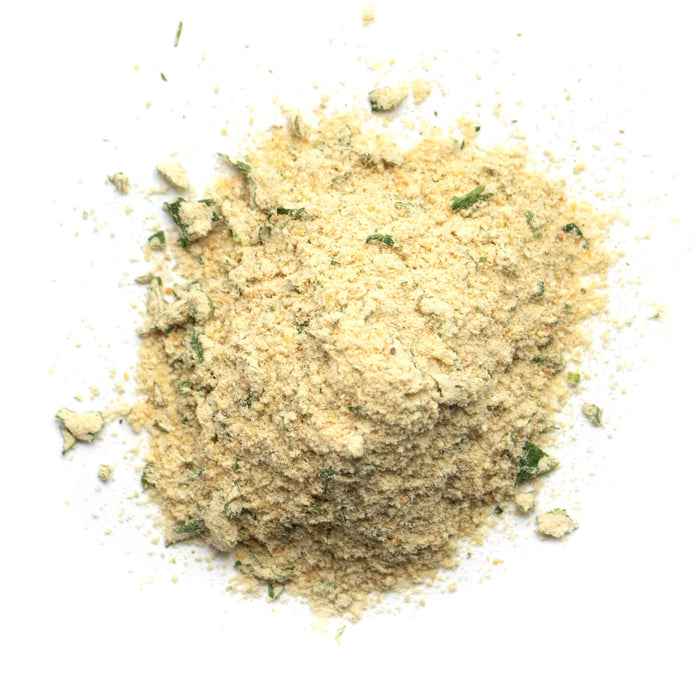 Closeup of off white powder with green flakes mixed in